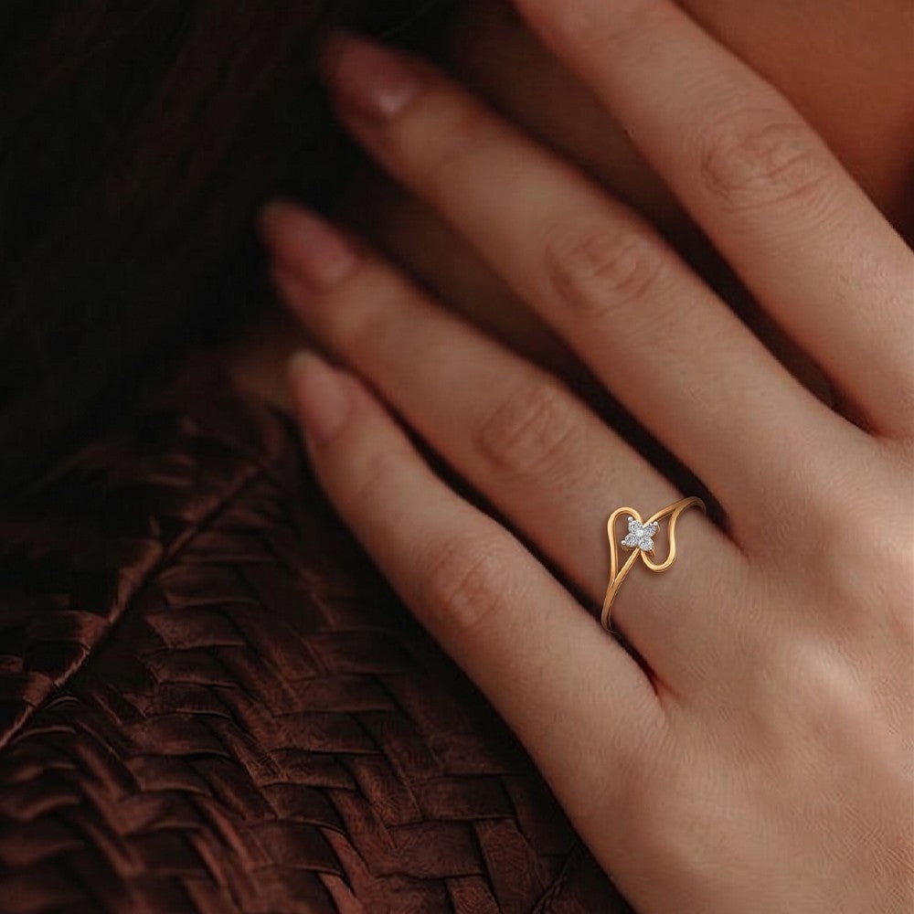 Close-up shot of a gold and diamond with floral design ring.