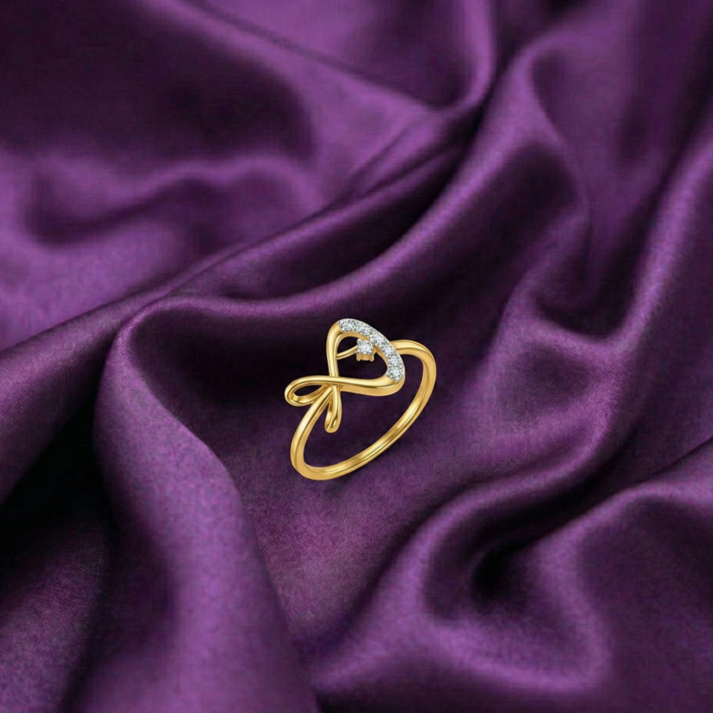 Gold and diamond women's ring on a fabric surface.