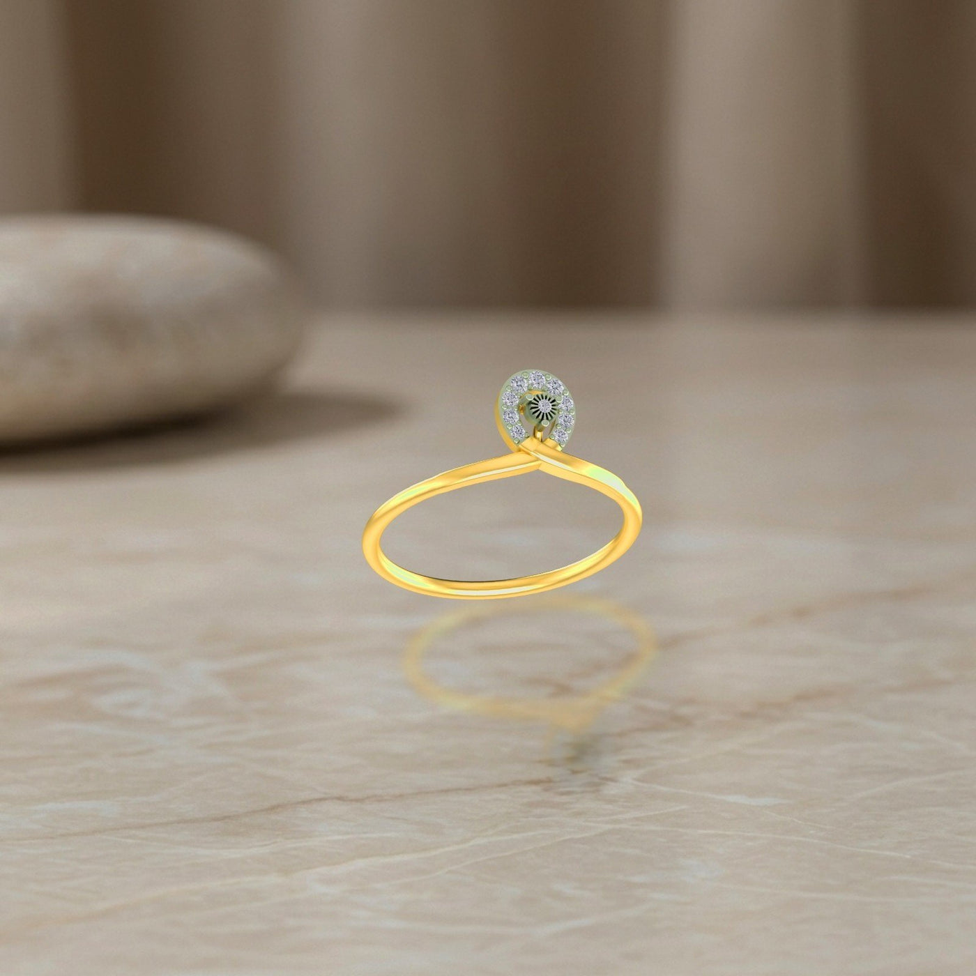 Gold and diamond ring on a reflective surface.
