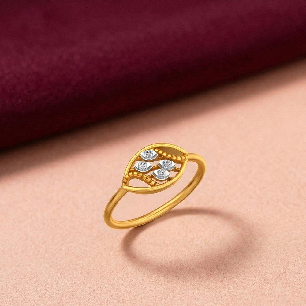 Gold ring with diamonds on a pink texture surface.