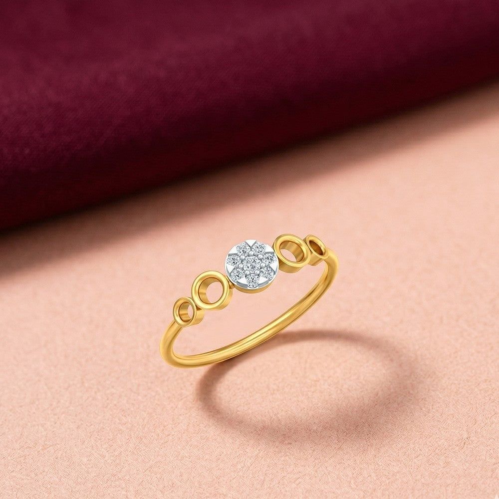 Gold and diamond with round-shaped cluster setting on a pink surface.
