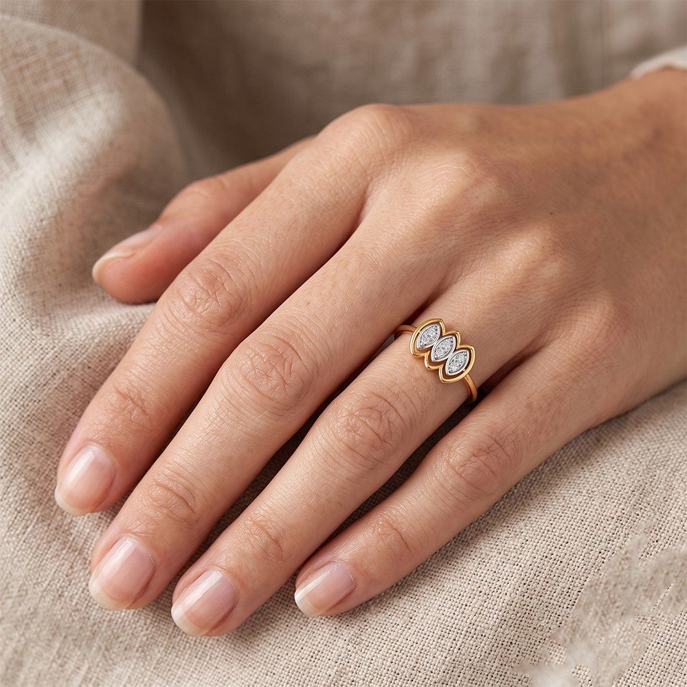 A close-up of a hand wearing a gold ring with three marquise-cut, resting on a textured beige fabric background.