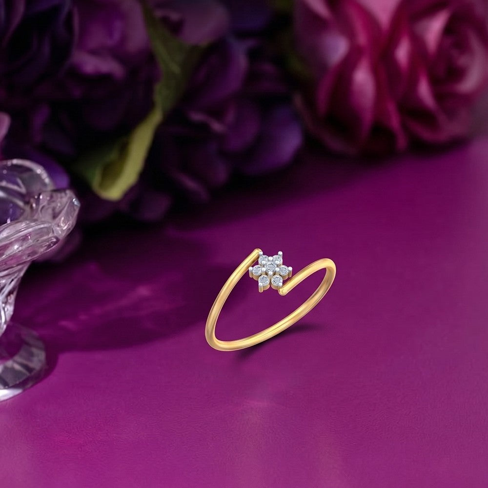 Gold and diamond with cluster setting on a purple surface.