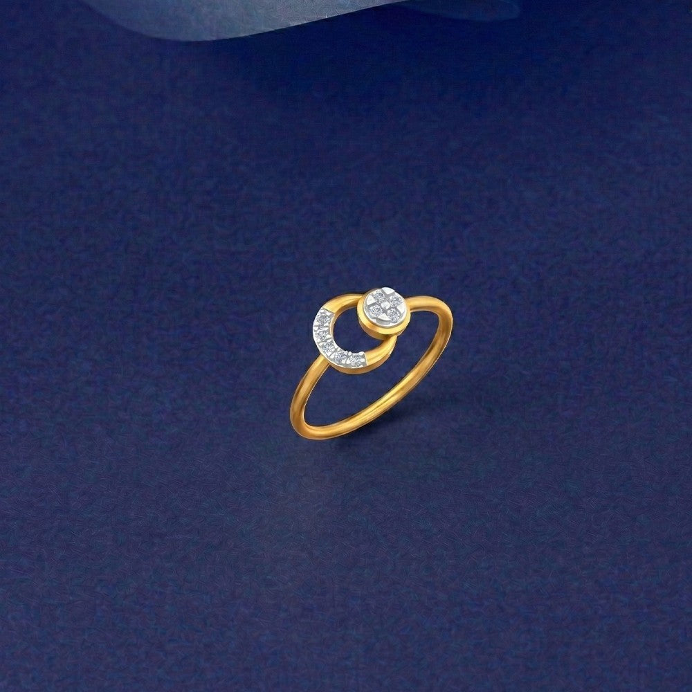 Gold and diamond circular ring on a blue surface.
