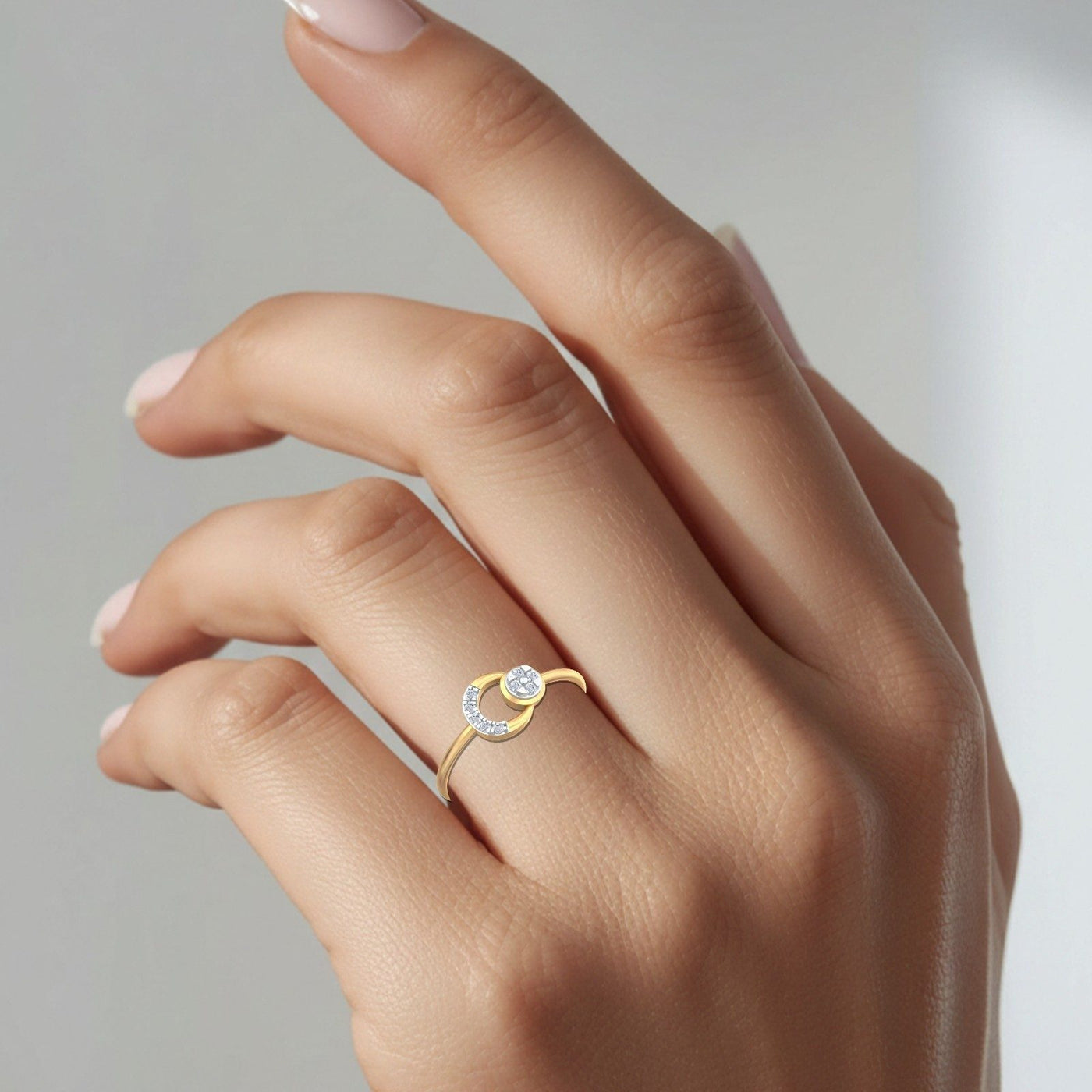 Close-up hot of a gold and diamond circular ring.