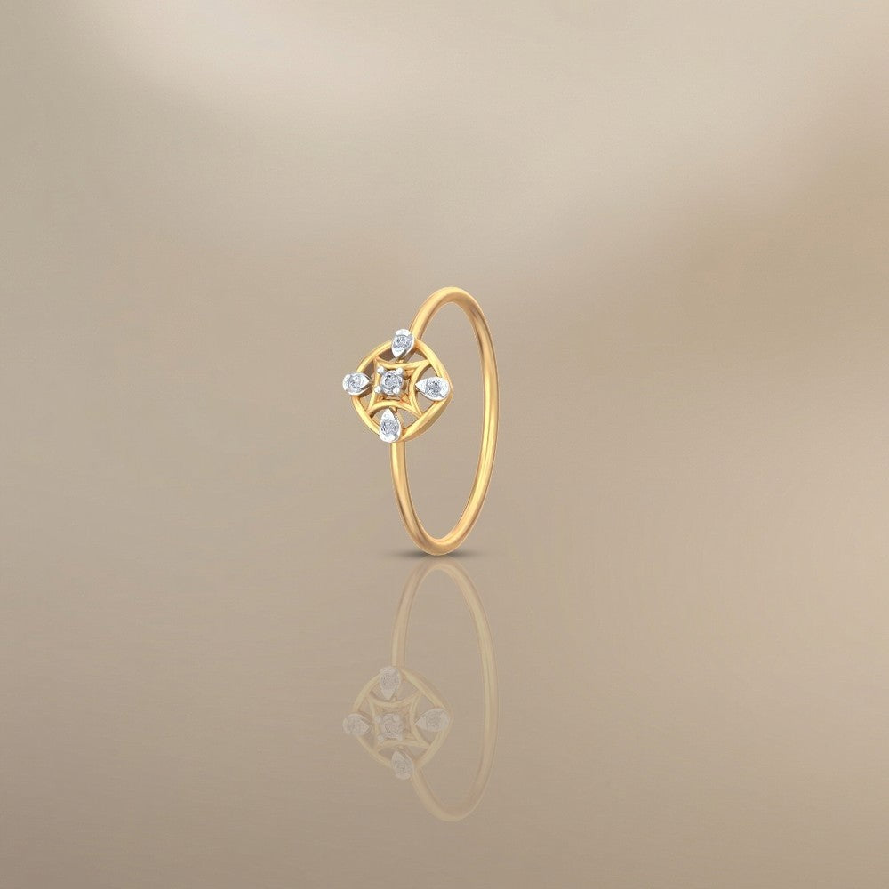 Gold ring with diamond-like stones on a beige background