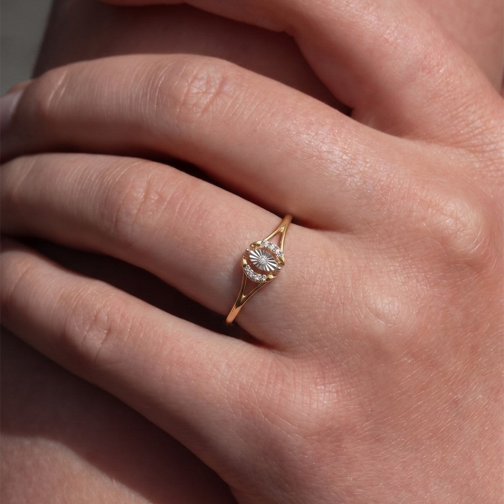 Close-up shot of  agold and diamond women's ring.
