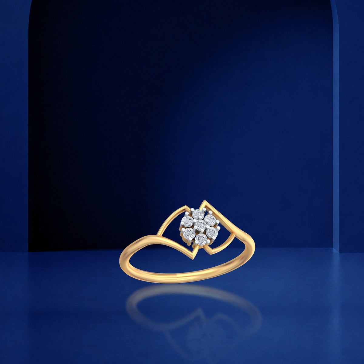 Gold and diamond with floral cluster setting on a blue reflective background.