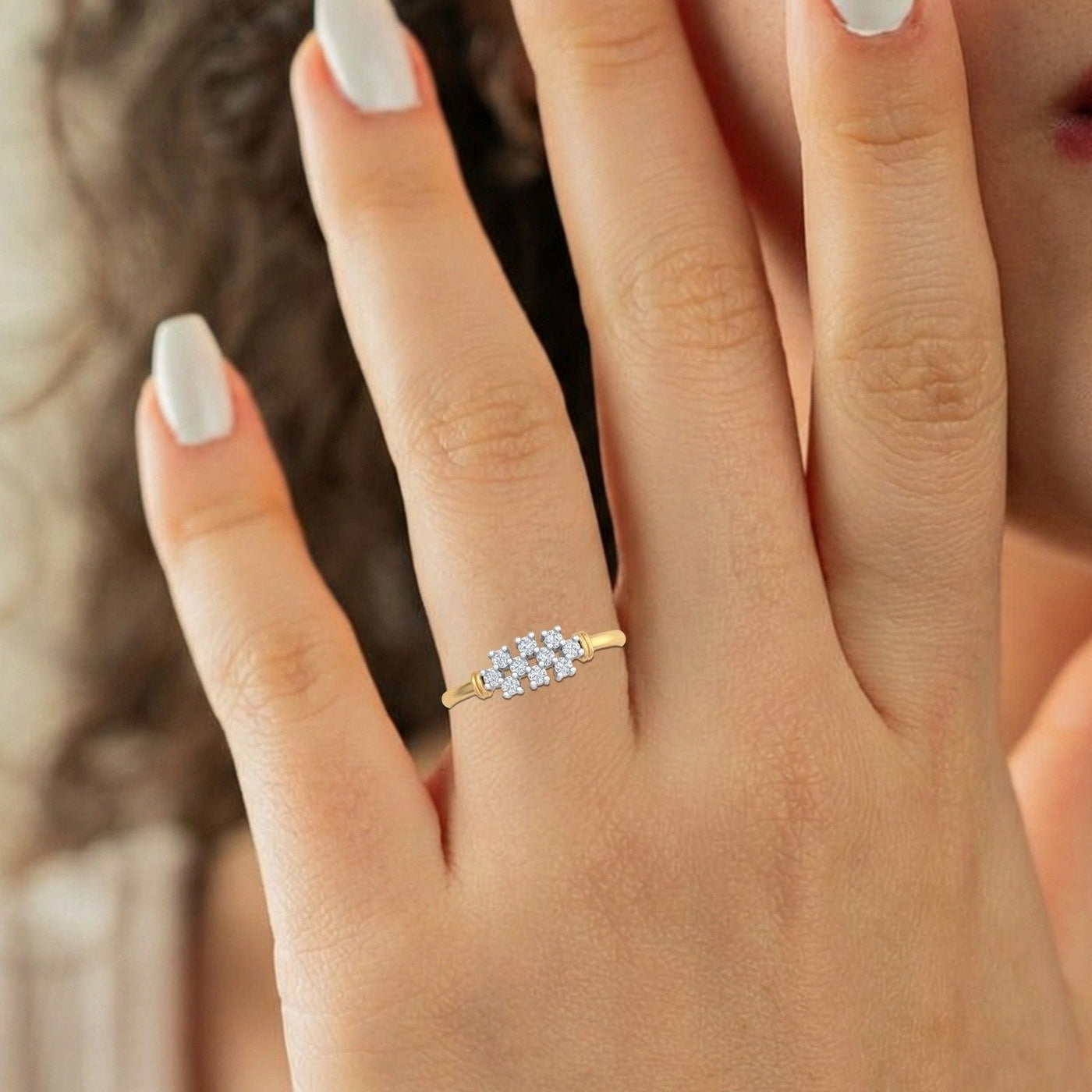 Gold and diamonds with cluster setting on a hand 