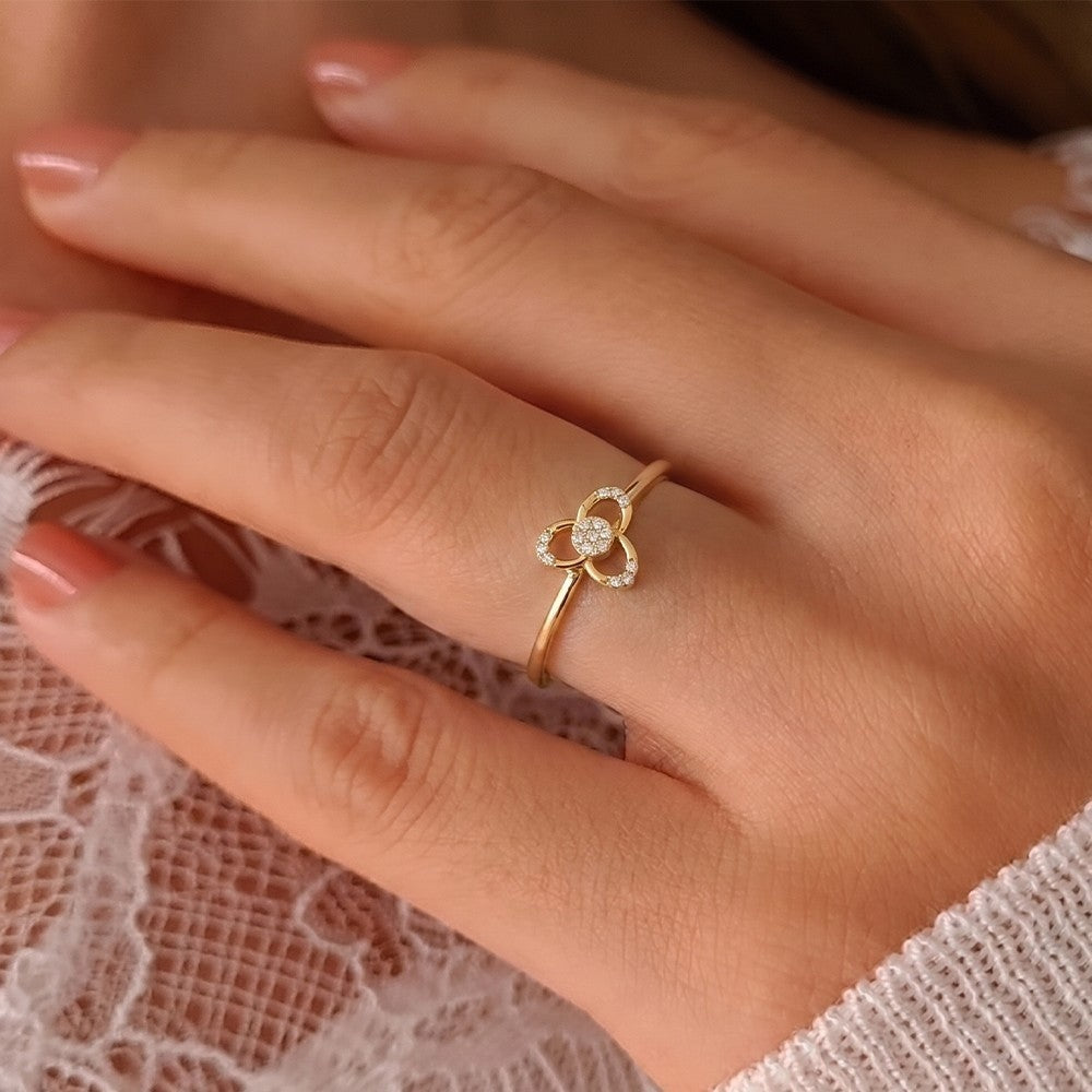 Close-up shot of a gold and diamond with floral design women's ring.