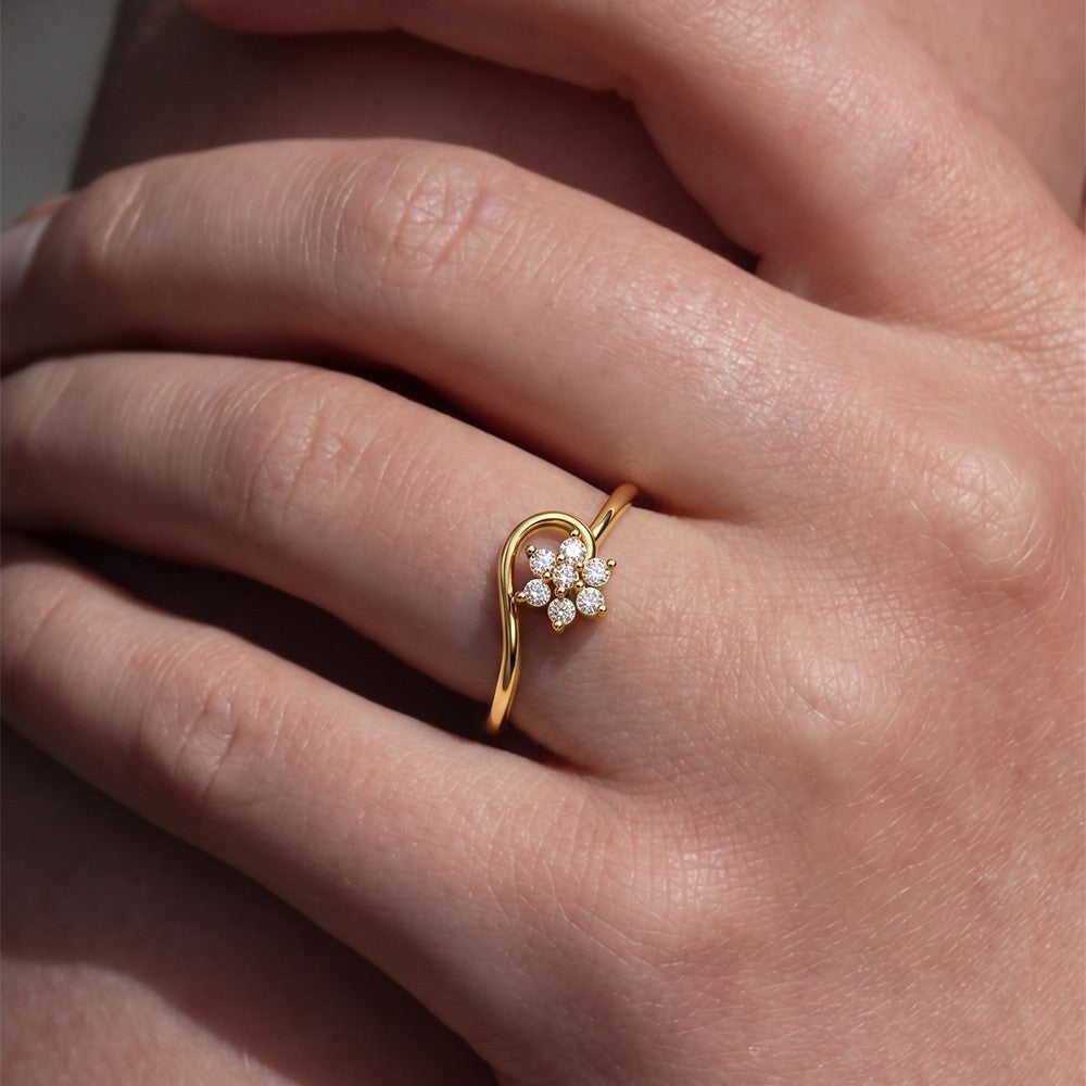 Close-up shot of a gold and diamond with floral design ring.