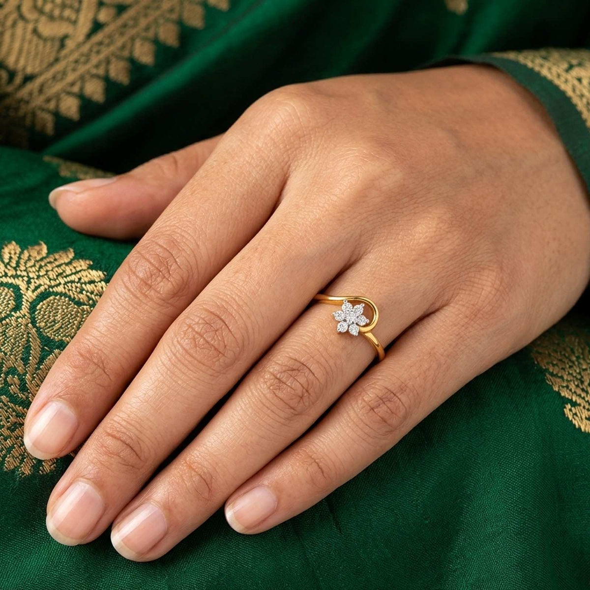 Gold and diamond with floral design on a green saree.