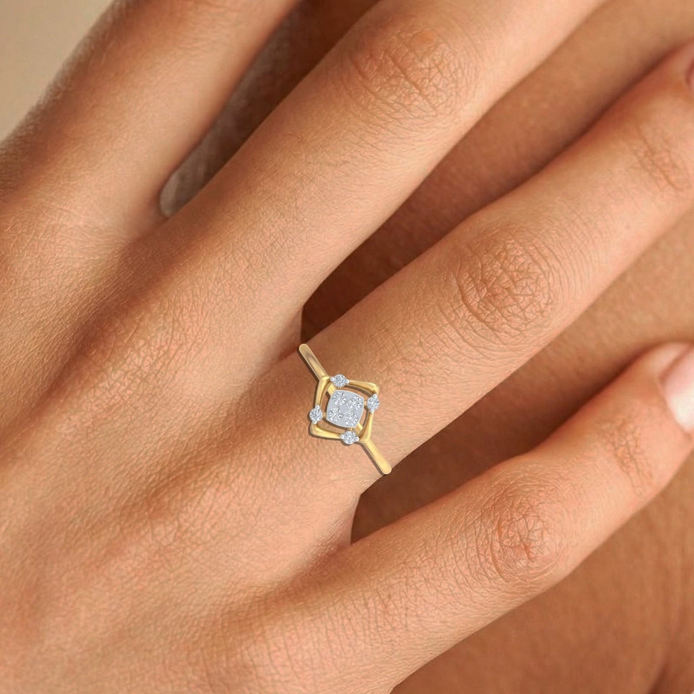 Gold ring with a diamond on a person's finger against a neutral background