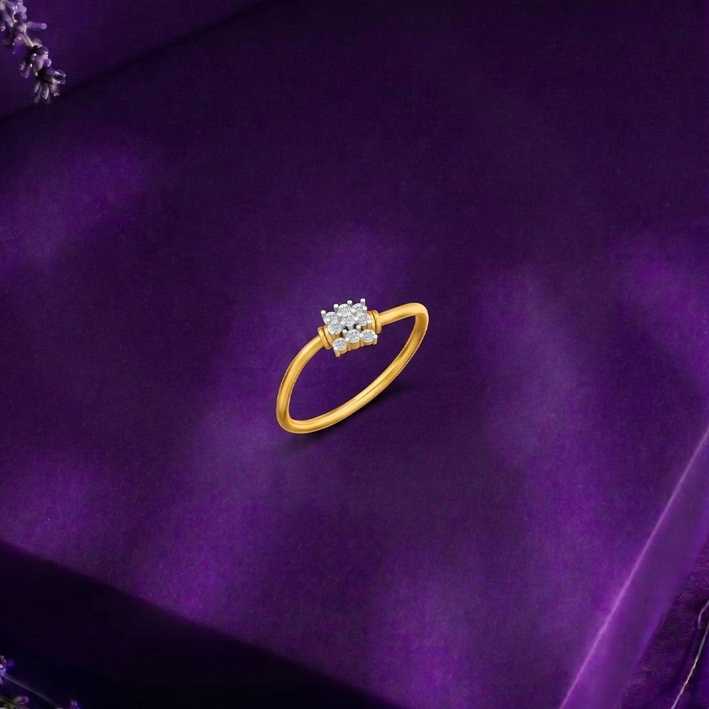 Gold ring with a diamond on a purple fabric background
