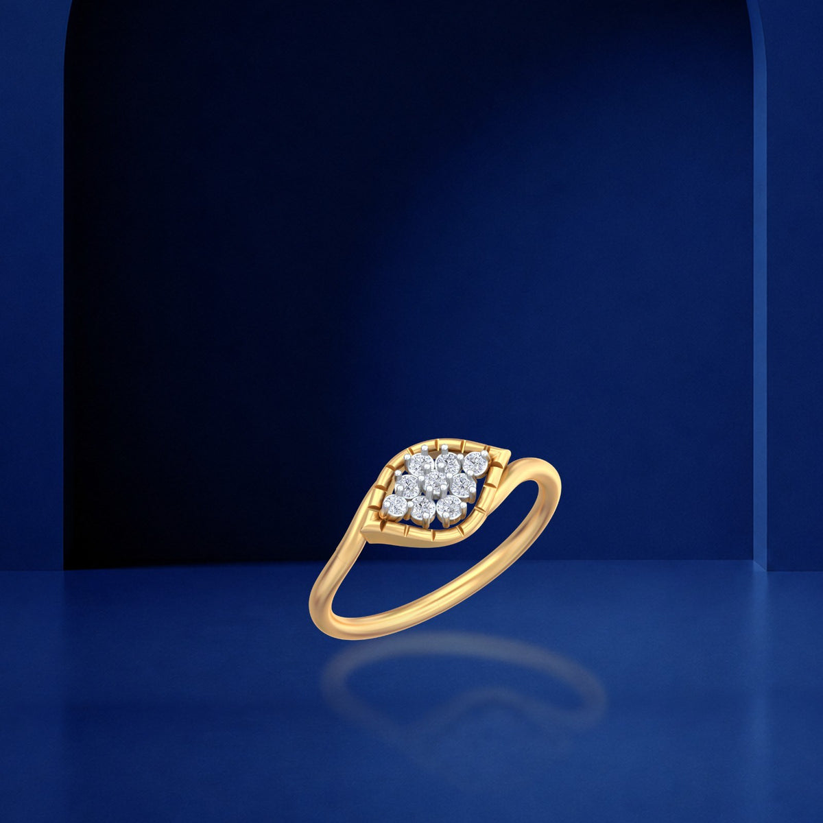 A yellow and diamond gold ring with a marquise-shaped cluster, displayed on a dark blue reflective surface.