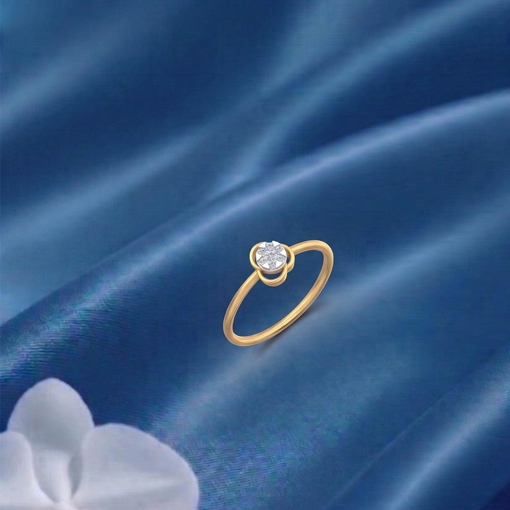 Gold and diamond with floral cluster on a blue satin surface.