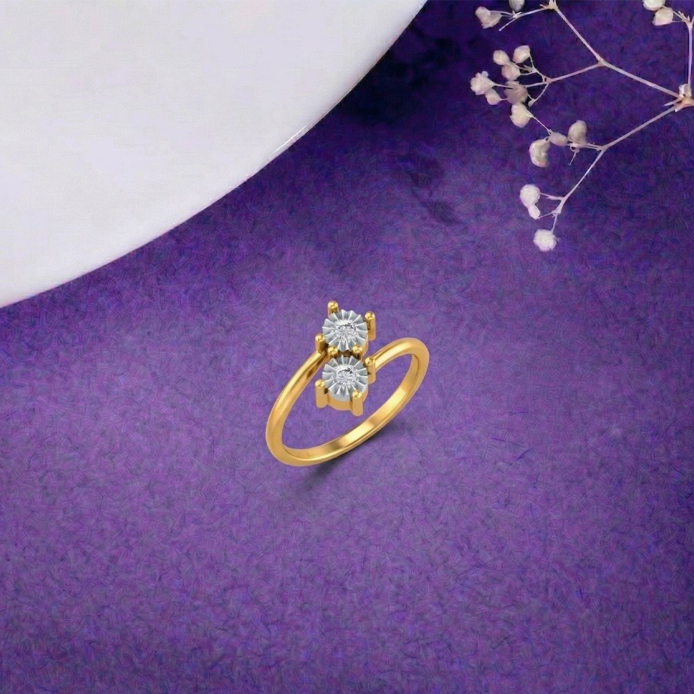 Gold ring with two diamonds on a purple surface