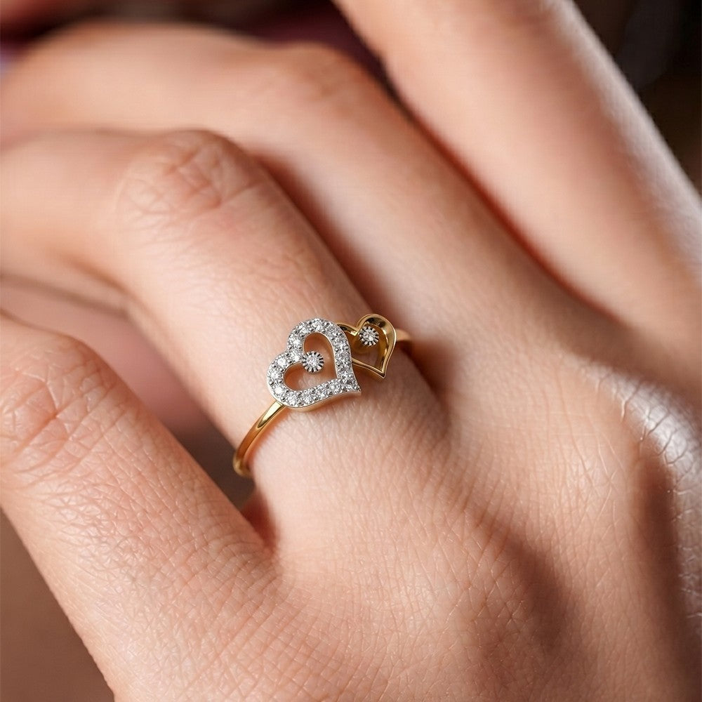Gold heart-shaped ring with diamonds on a hand