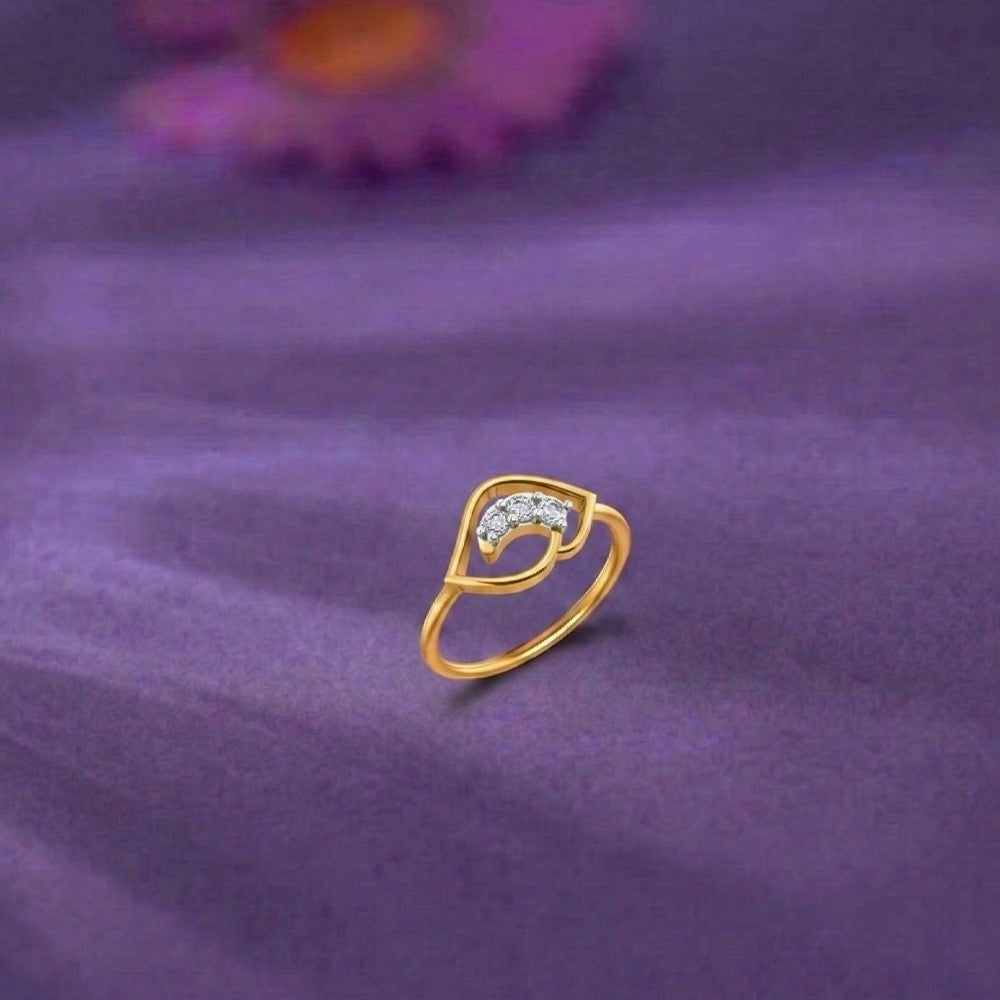 Gold ring and diamond on a purple fabric background