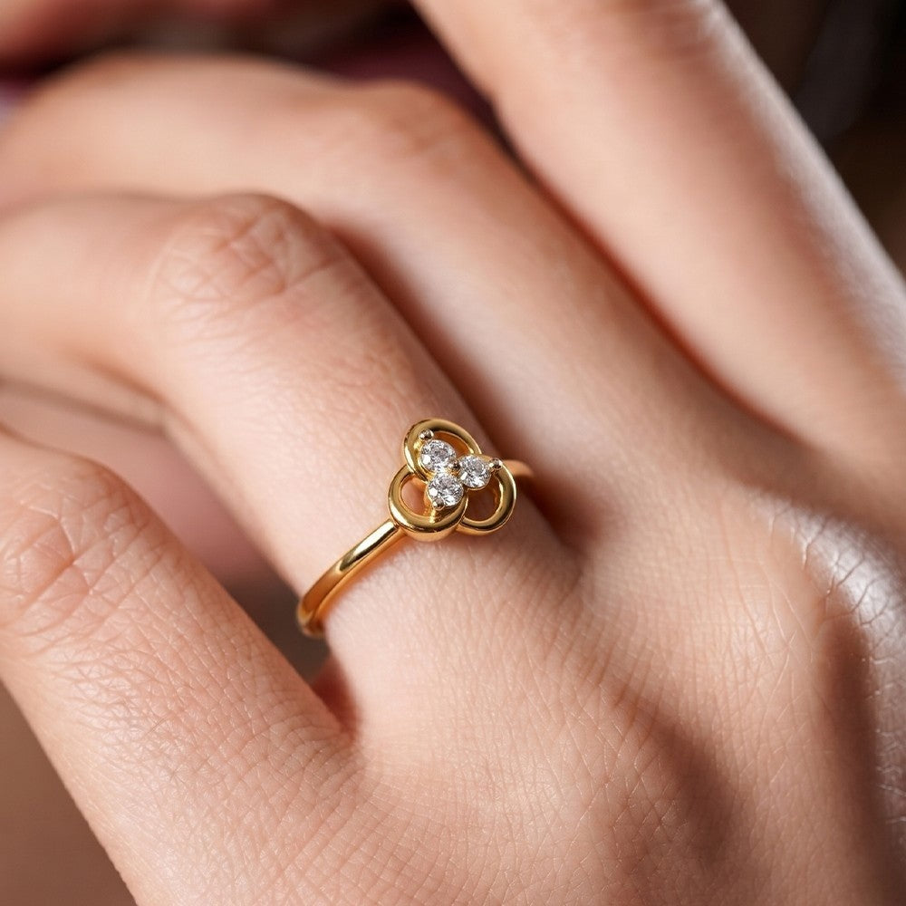 Close-up shot of a gold and diamond with floral ring.