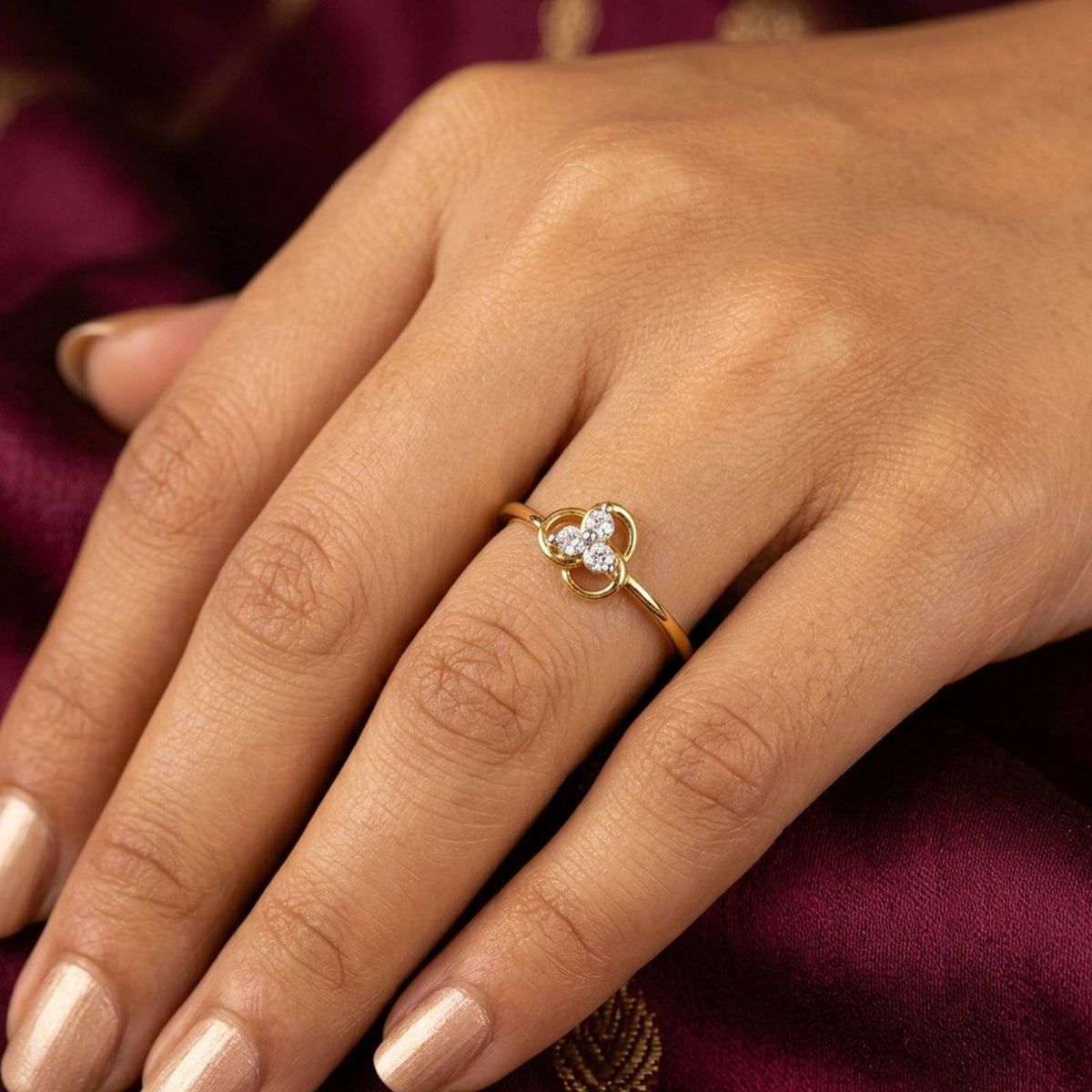 Close-up shot of a gold and diamond with floral ring.
