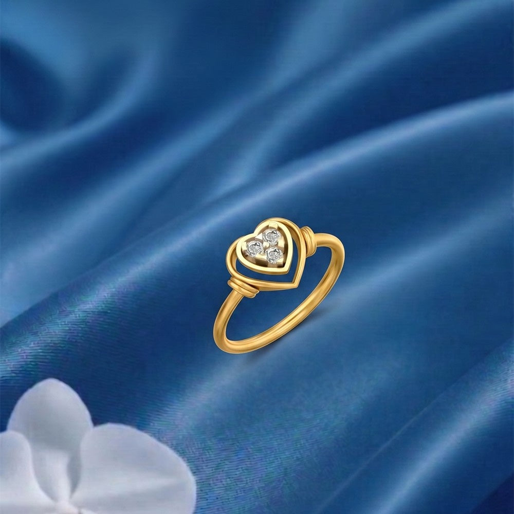 Gold heart-shaped ring with diamonds on a blue satin background