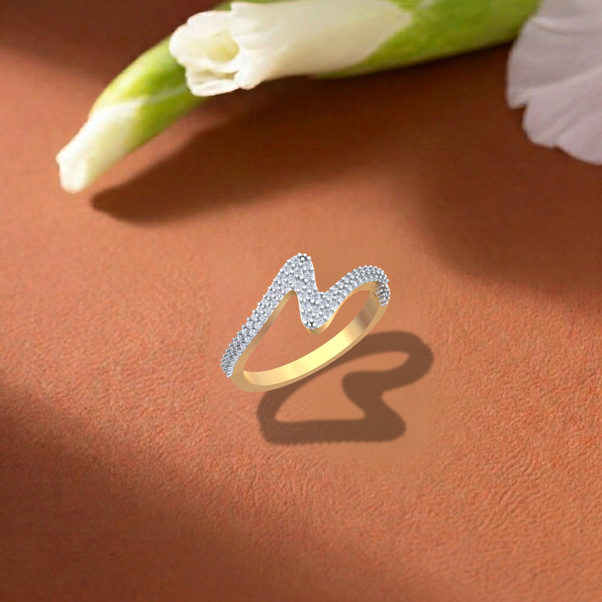 A gold and diamond with half-eternity ring, resting on a textured brown surface.