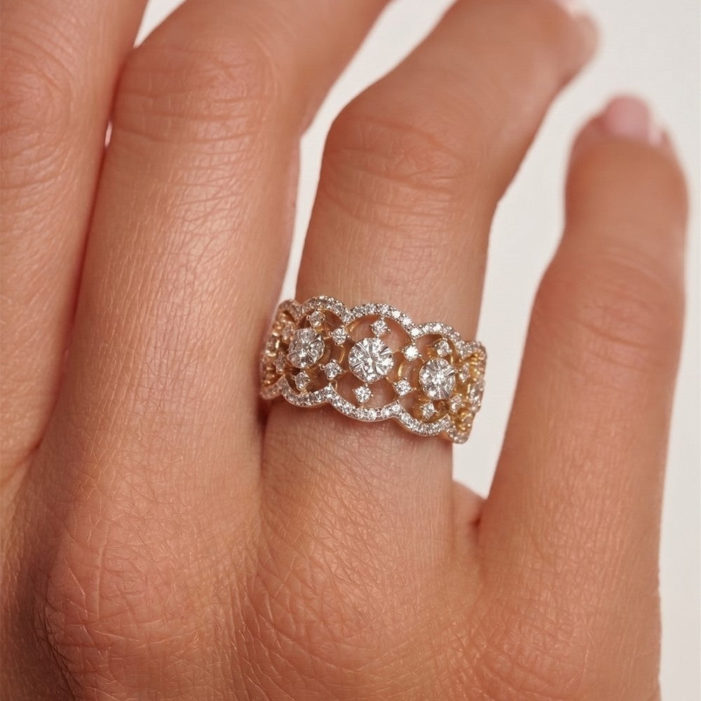 Rose gold ring with diamonds on a finger against a white background