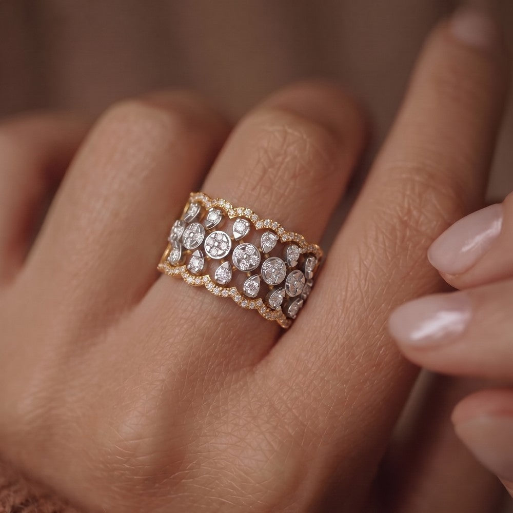 Close-up of a hand wearing a  gold and diamond ring.