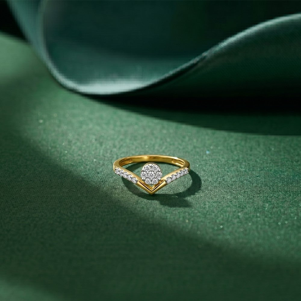 Gold ring with diamonds on a green surface