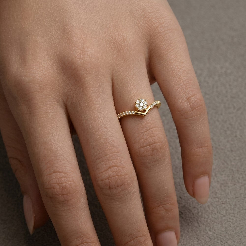 Close-up shot of a gold and diamond with cluster setting women's ring.