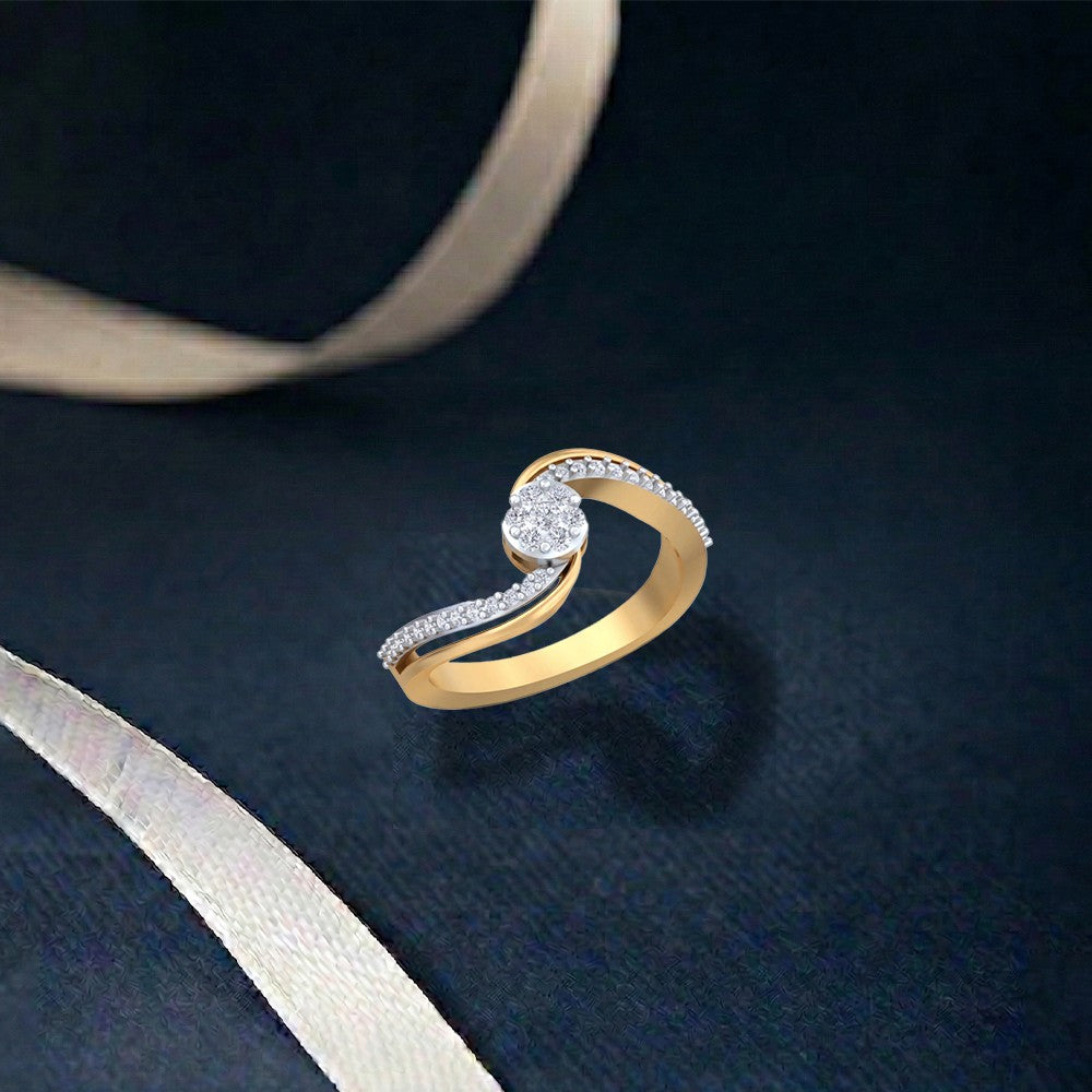 A gold ring with a twisted, featuring a round-cut clear center stone, displayed on a dark textured background with a light beige ribbon.