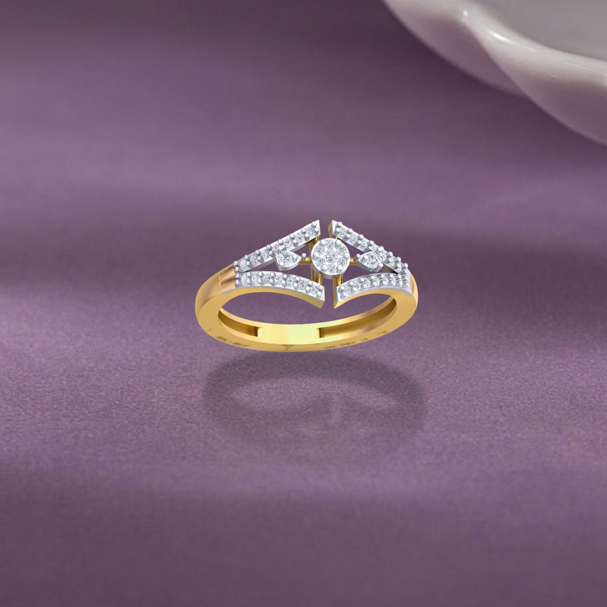 Gold and diamond with cluster ring on a purple surface.