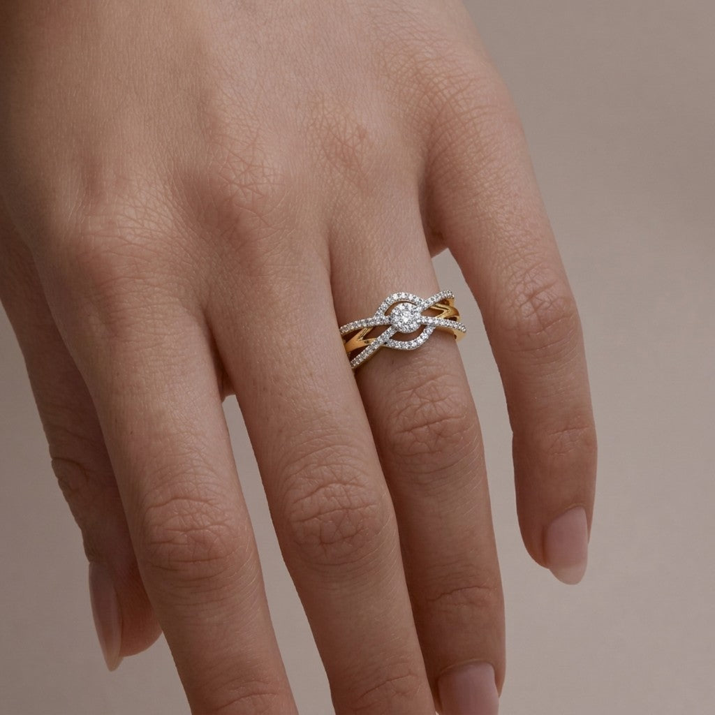 Gold ring with a diamond on a person's finger against a neutral background