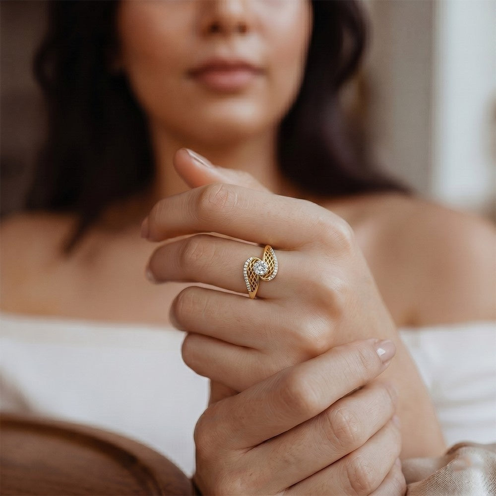 Close-up of a woman's hand wearing a gold ring with a diamond, blurred background