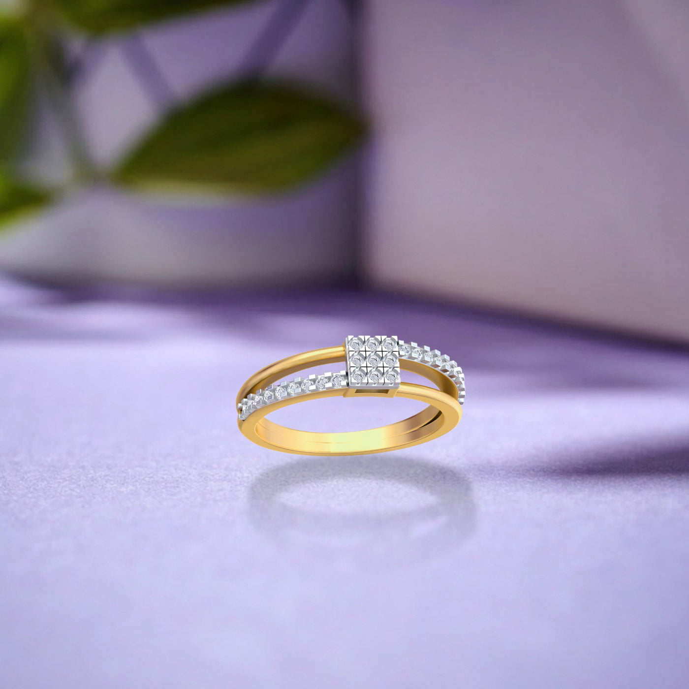 A gold and diamond ring with square cluster on a soft lavender surface with a blurred background.