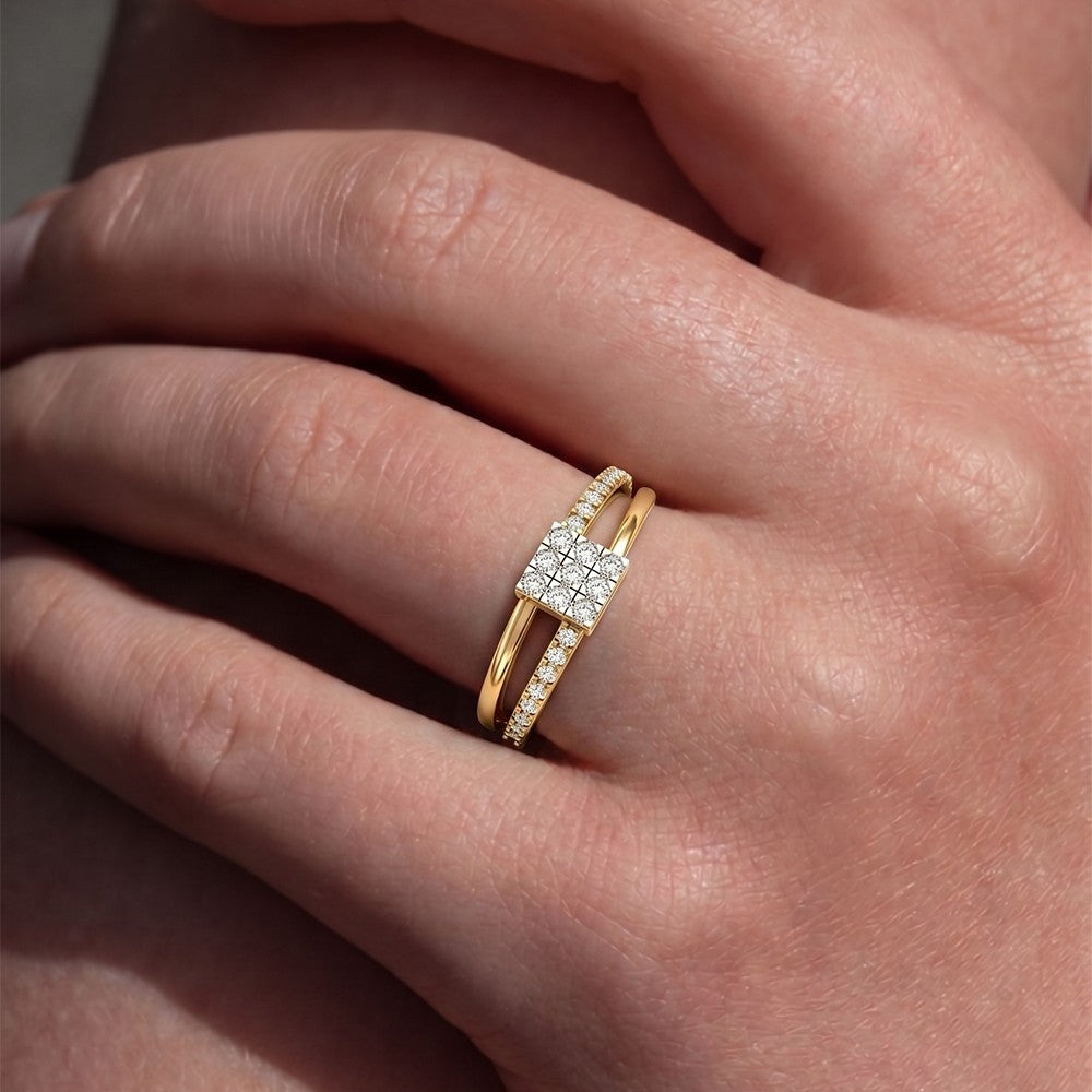 Gold ring with diamonds on a person's finger.