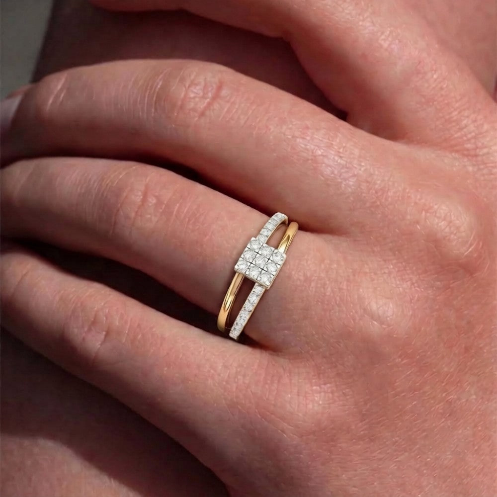 Gold ring with diamonds on a person's finger.