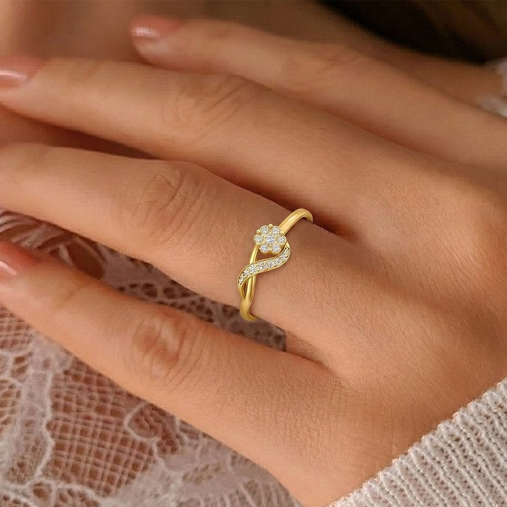 Close-up shot of a gold and diamond with floral ddesign ring.