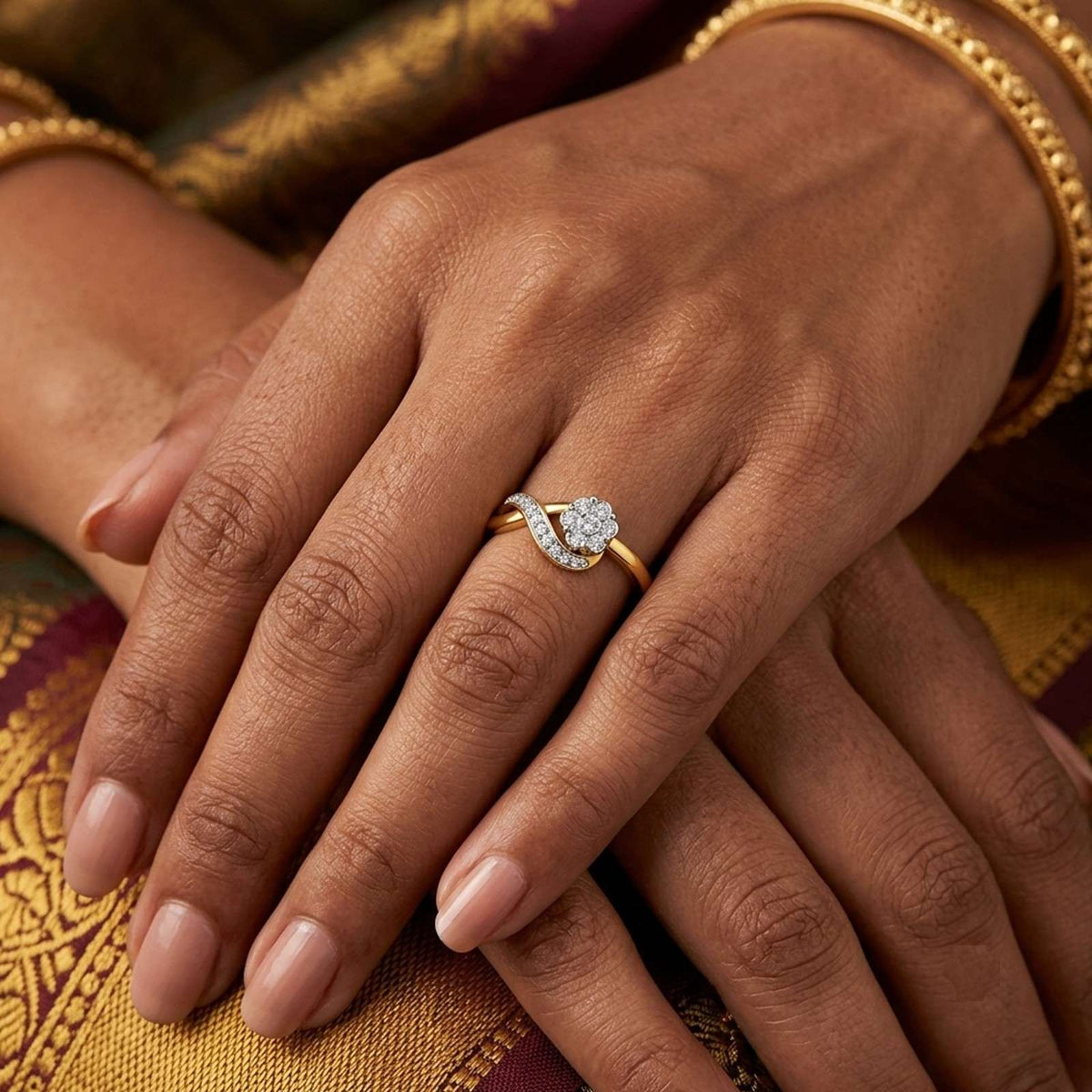 Close-up shot of a gold and diamond with floral design ring.