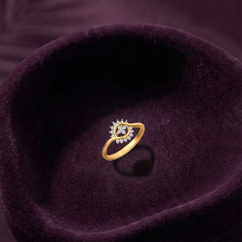 Gold ring with a diamond on a purple fabric background