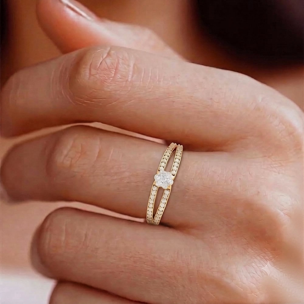 Gold ring with a diamond on a person's finger against a blurred background