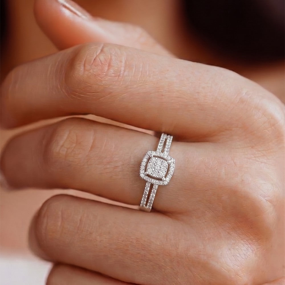 Gold and diamond ring with a diamond on a person's finger
