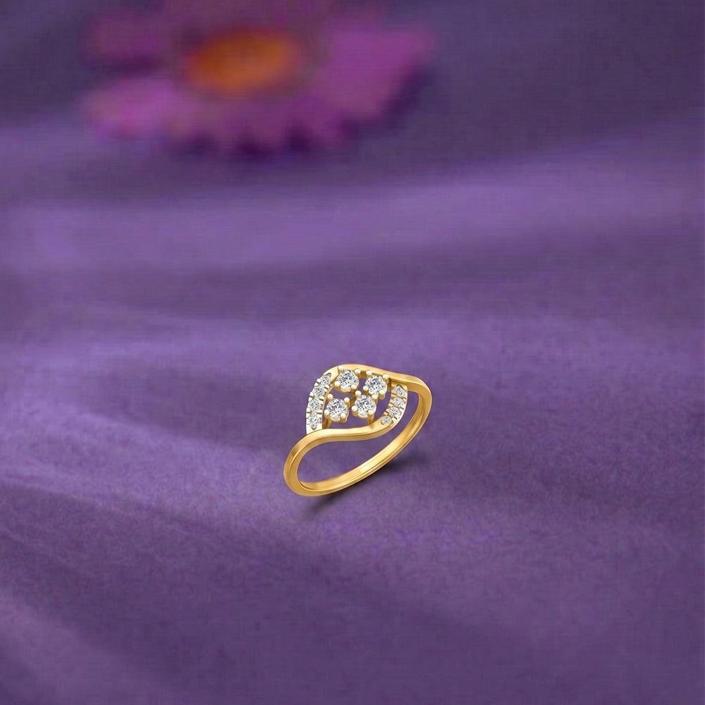Gold and diamond with cluster setting on a purple surface.