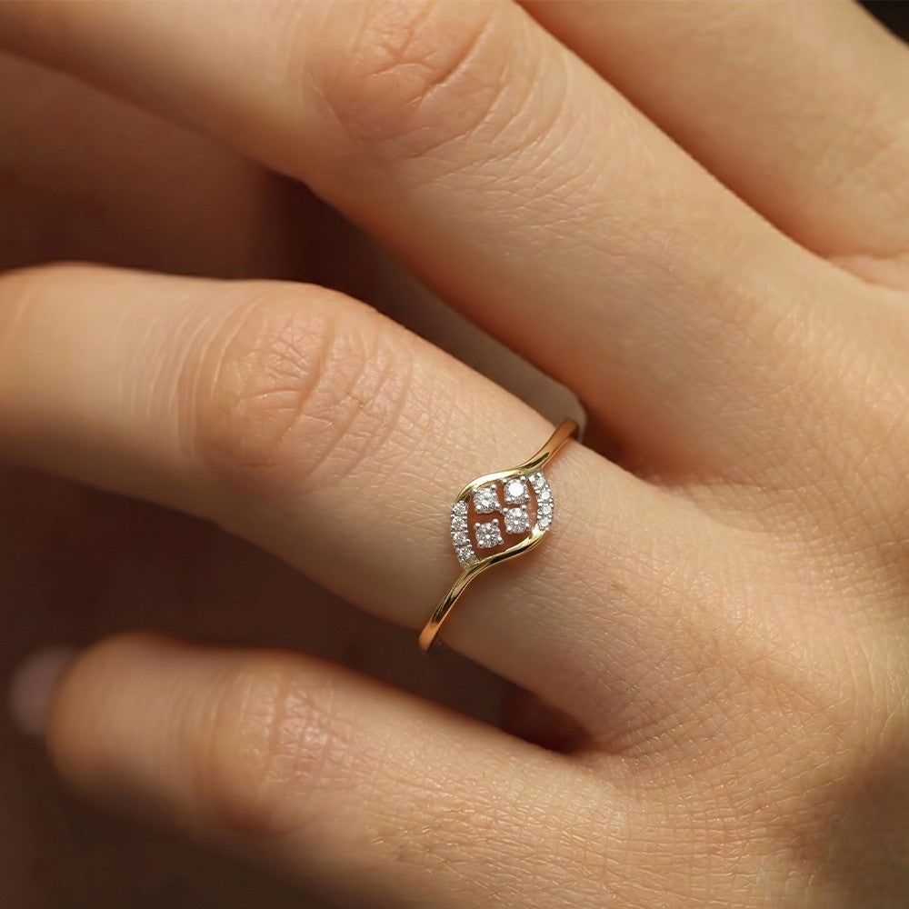 Close-up shot of a gold and diamond with cluster setting ring.
