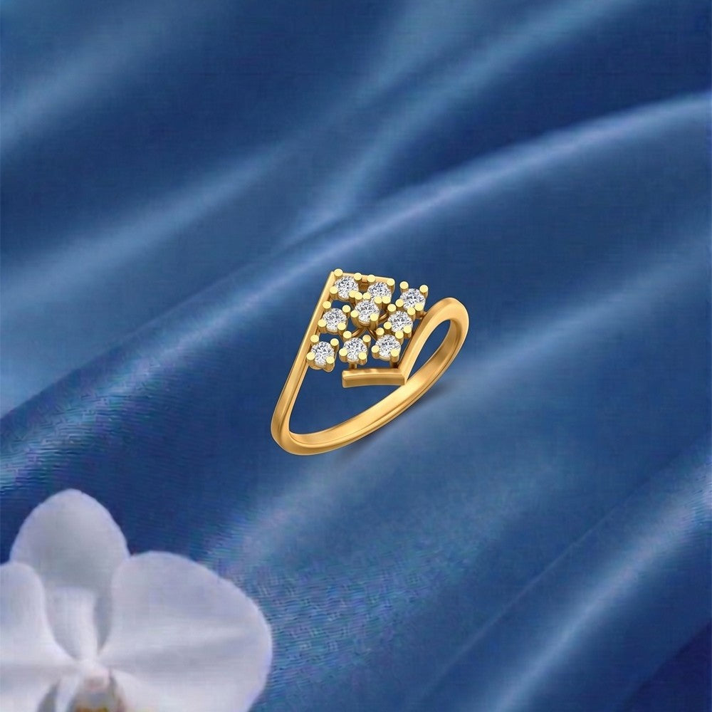 Gold ring with diamonds on a blue satin background