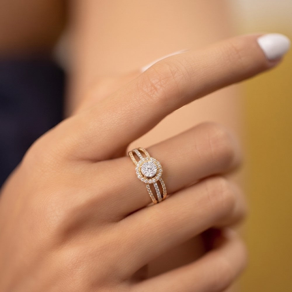 Close-up of a hand wearing a rose gold ring with a diamond on a blurred background