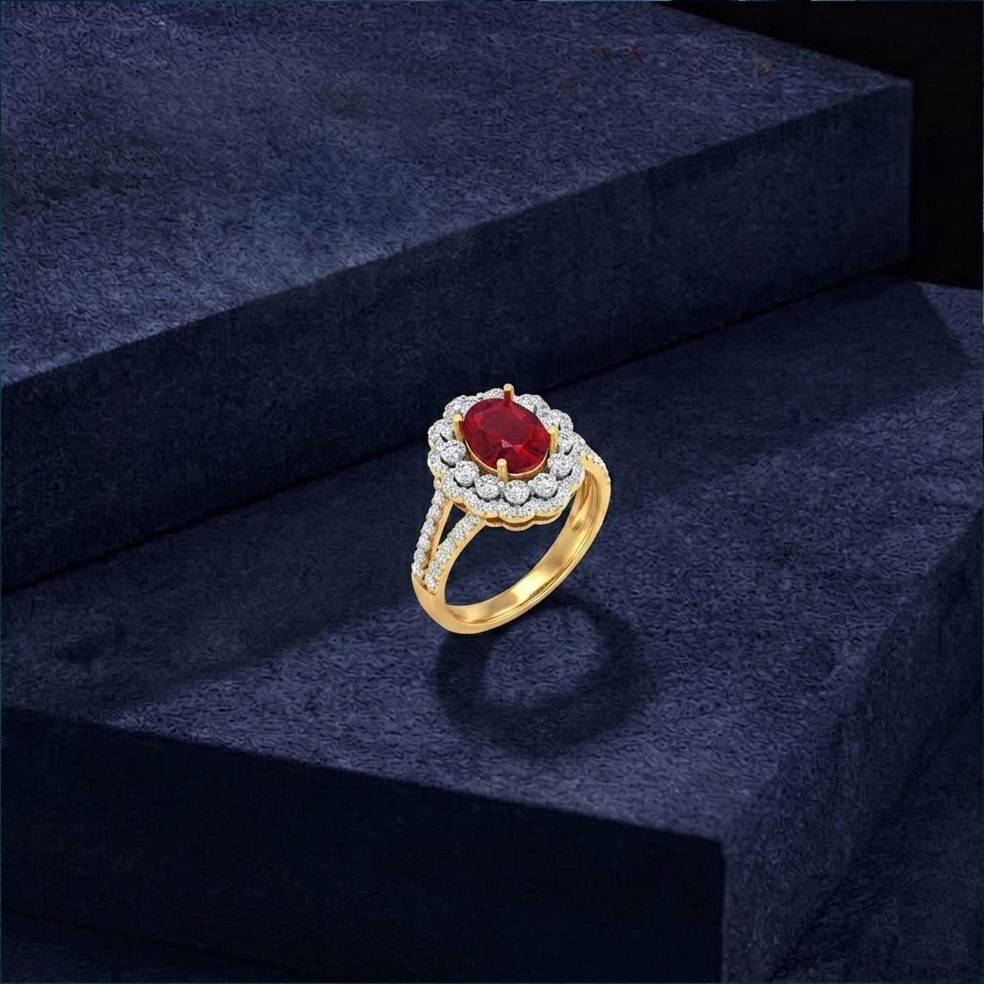 Gold ring with a red gemstone on a dark blue surface
