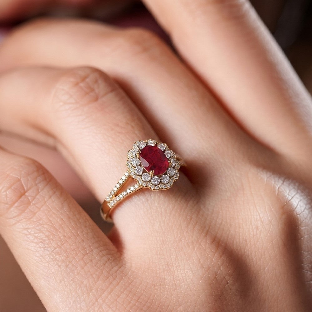Gold ring with a red gemstone on a hand