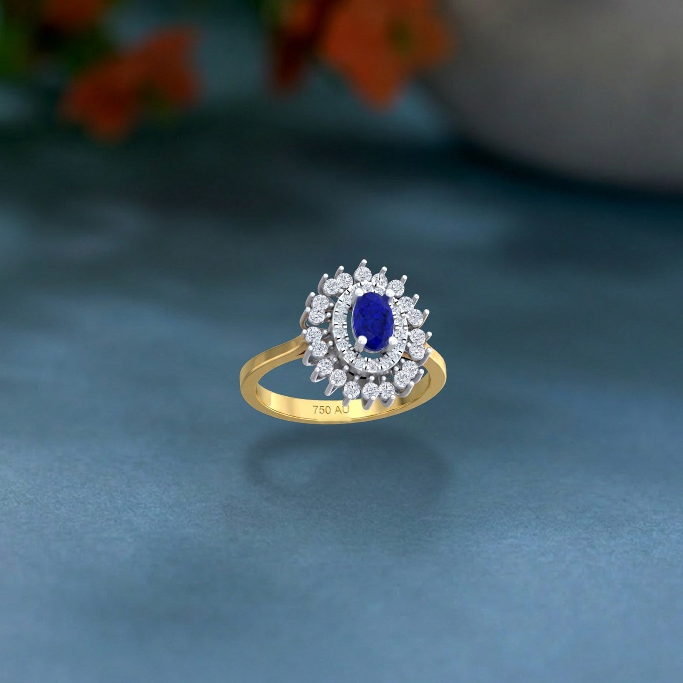 Gold ring with a blue gemstone and diamond accents on a gray background